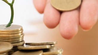 Businessman With Coin Plant