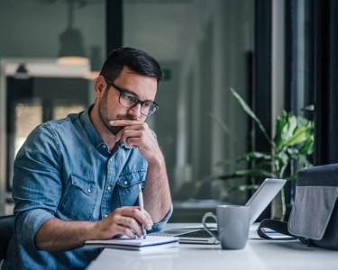 Man thinking while on the laptop
