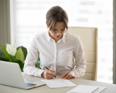 Business woman signing a document