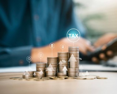 Businessmen use a computer to complete Individual income tax forms online for tax payment. Government state taxes, Data analysis, paperwork, financial research, report and Calculate tax refund.