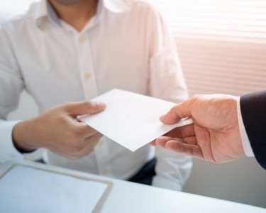 Business man given a pay packet