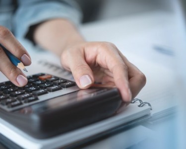 Business woman calculating company bills