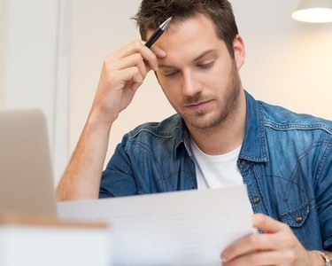 Man Looking At A Statutory Demand