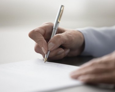 Woman signing a document