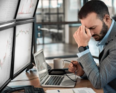Unhappy man looking at trading