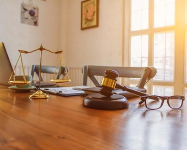 The Mallet And Brass Scales Are Placed On The Table In The Lawyers Office For Decorative Purposes