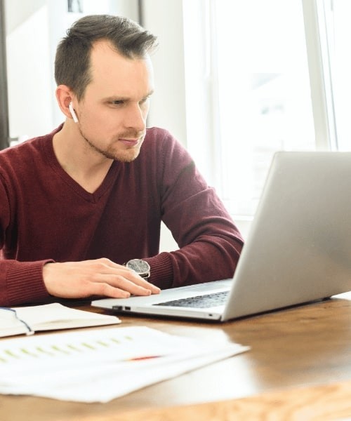 Man With Airpods On Laptop